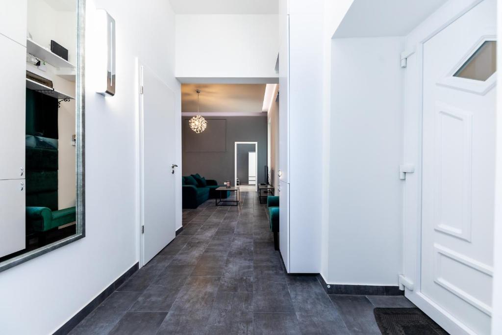 a hallway leading to a living room with white walls at High end 2 bedroom apartment in downtown in Budapest