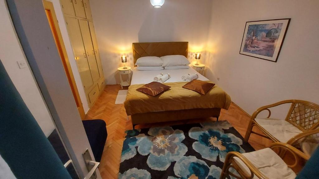 a small bedroom with a bed and a rug at House Lanterna Pag in Pag