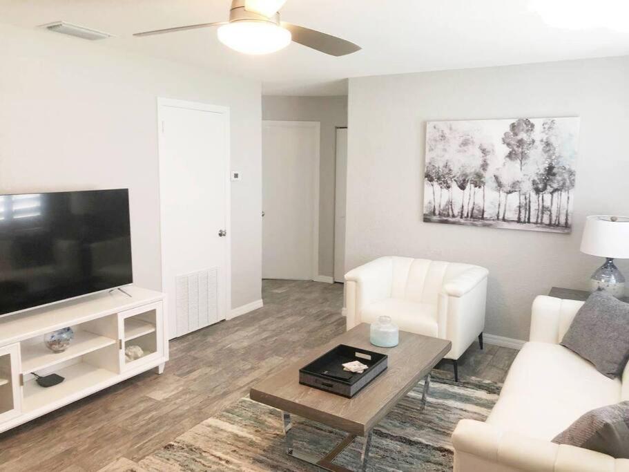 a living room with a couch and a tv at Modern Apartment - 1 of 4 in Punta Gorda