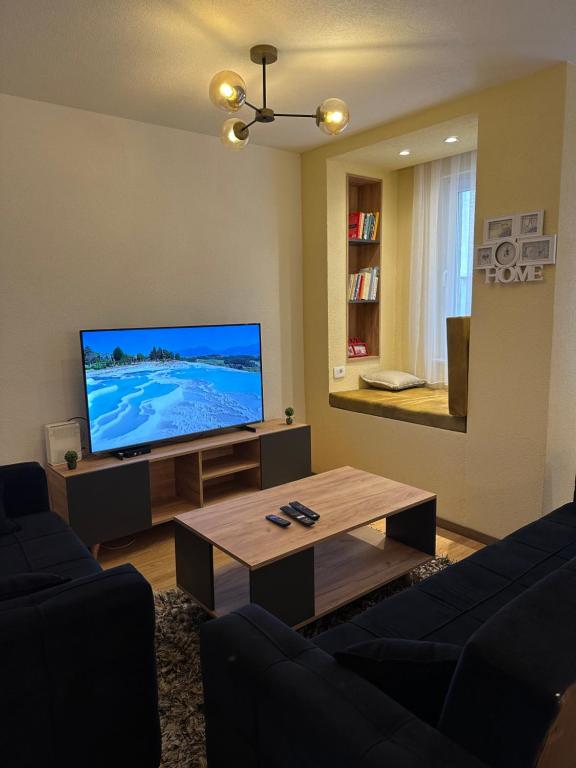 a living room with a large flat screen tv at ORA-PRN,peaceful central apartment in Pristina