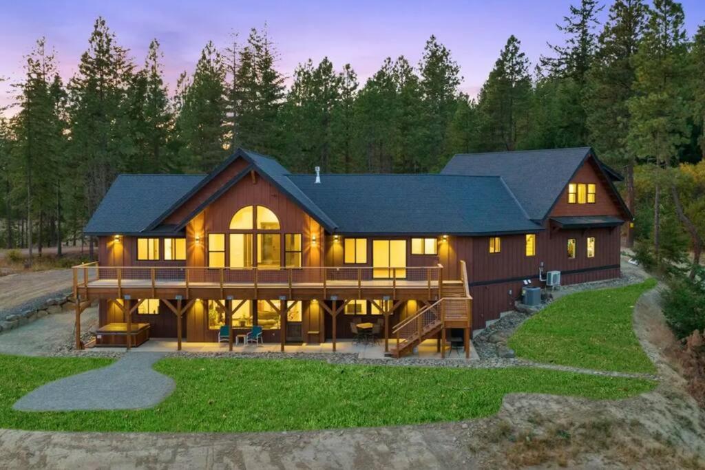 a large wooden house with a large deck at Summit House in Cle Elum