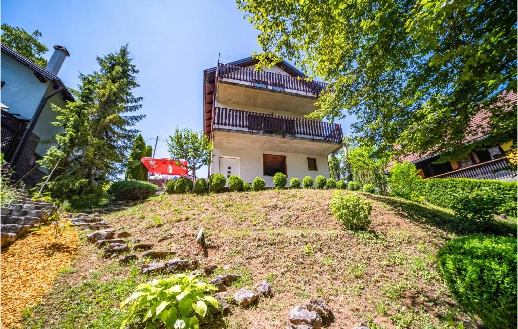 a house on a hill with a yard at Amazing Home In Duga Resa With House A Panoramic View in Duga Resa