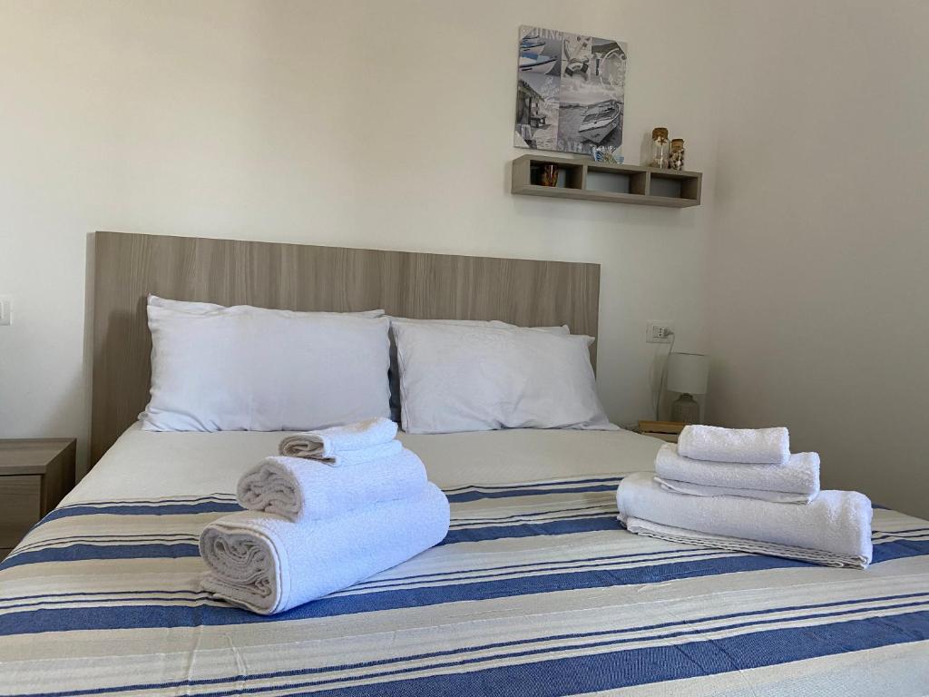 - un lit avec des serviettes assises au-dessus dans l'établissement Go Island, à Praia a Mare