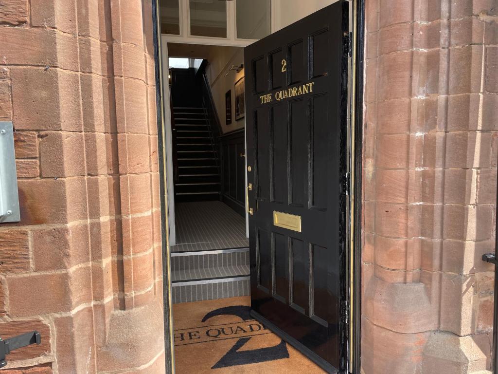 a door to the entrance of a brick building at 2 The Quadrant Luxury Apartments - Hoylake in Hoylake