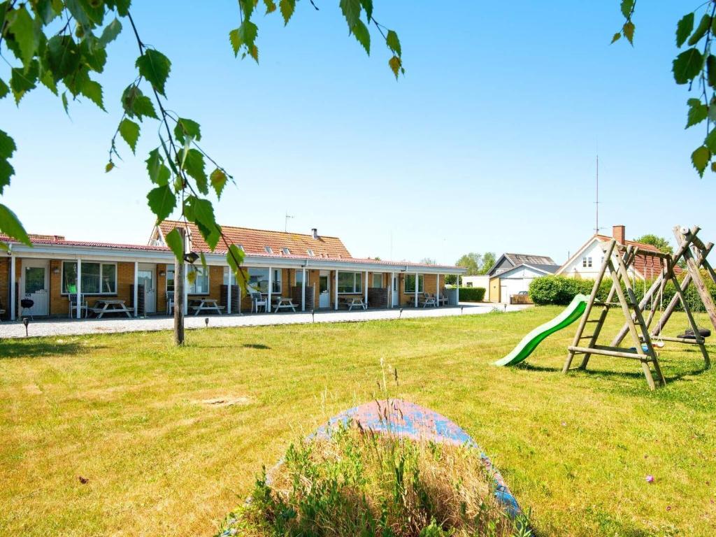 a yard with a playground and a building at 4 person holiday home in Sydals in Østerby
