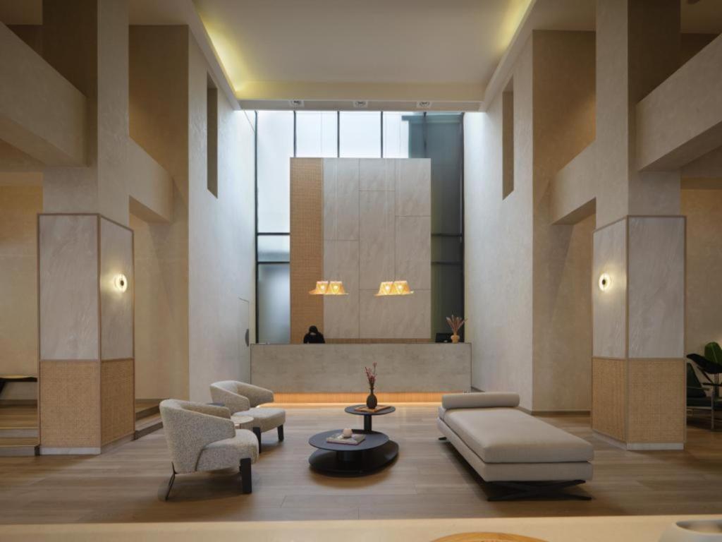 a lobby with a couch and chairs and a table at The Brunei Hotel in Bandar Seri Begawan