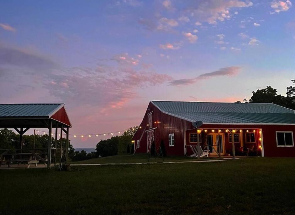 a red barn with a gazebo in a field at The Presidential Barndominium in the Stable at Bear Mountain in Eureka Springs