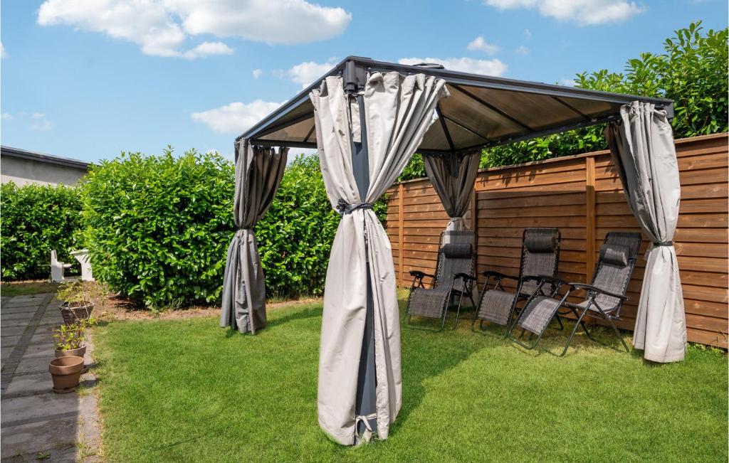 a gazebo with chairs under it on a lawn at Amazing Home In Glostrup With Wifi in Glostrup