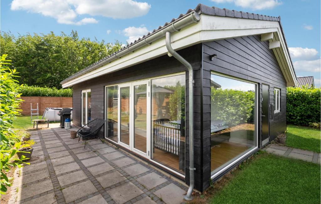 a garden room with sliding glass doors on a patio at Amazing Home In Glostrup With Wifi in Glostrup