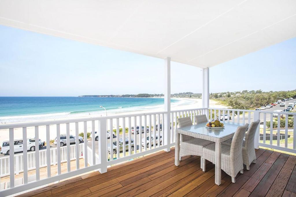 a balcony with a table and a view of the ocean at Pas Beach House Apartment 2 in Mollymook
