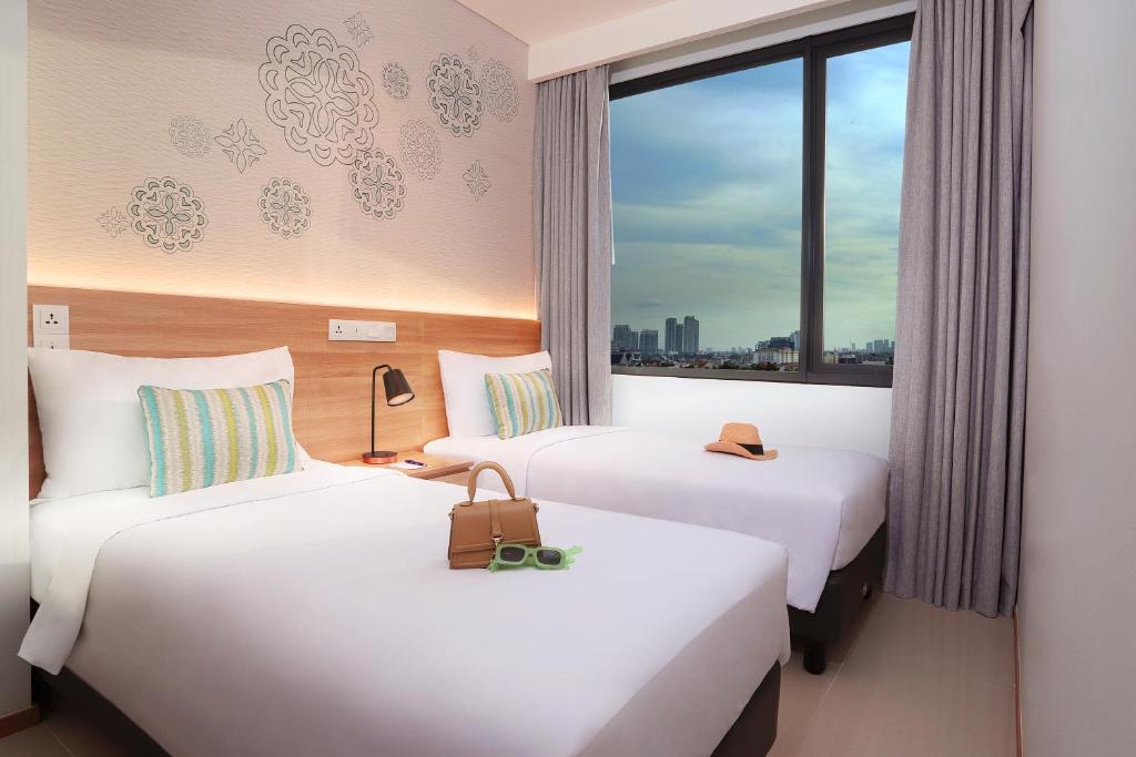 Postel nebo postele na pokoji v ubytování Citadines Gatot Subroto Jakarta