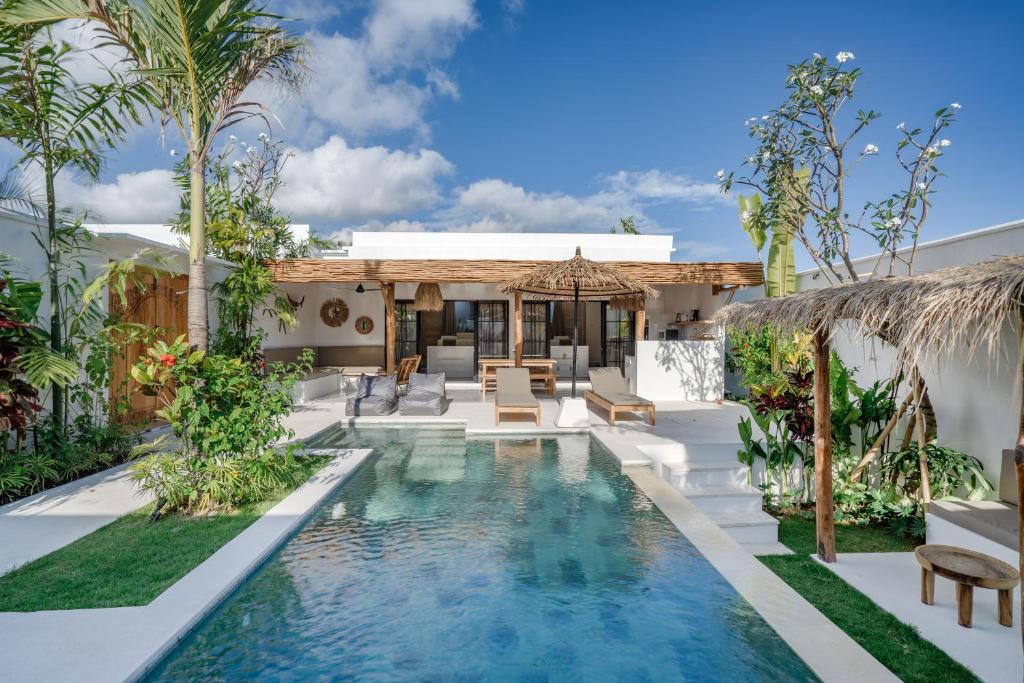 a swimming pool in the backyard of a villa at Villa Ruta II - Luxury 2BR tropical villa next to Luna BC and Nyanyi beach in Tanah Lot