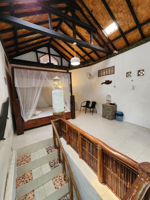 a view of a room with a bed and stairs at Jungle Inn Bukit lawang in Bukit Lawang