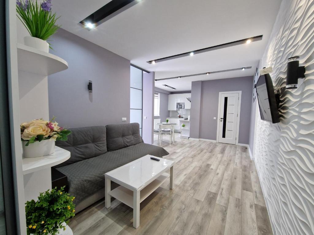 a living room with a couch and a table at Premium apartment on Belvedere in Ivano-Frankivsk