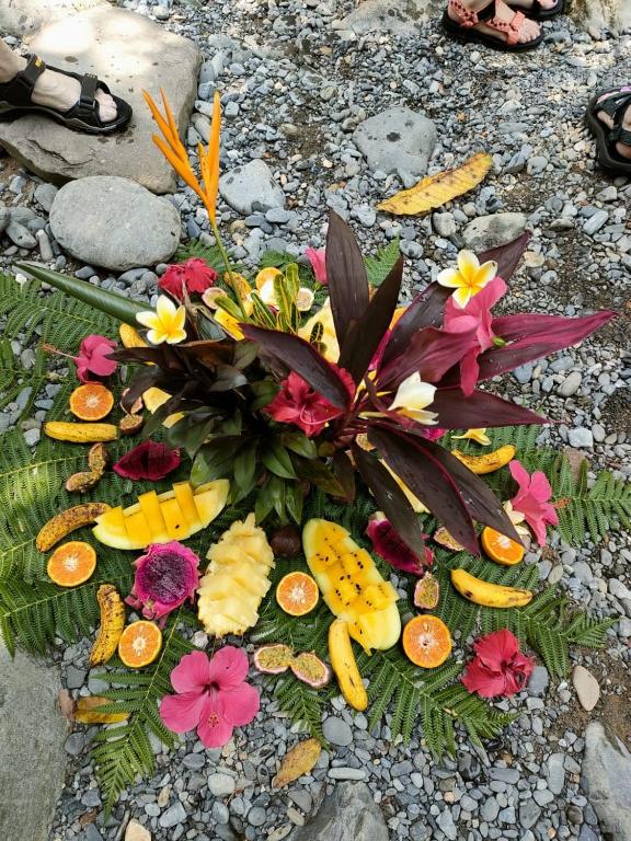a bouquet of flowers and fruits on the ground at Jungle Inn Bukit lawang in Bukit Lawang