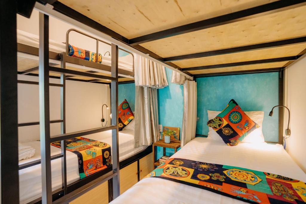 a bedroom with two bunk beds in a room at Hoi An Wanderlust - Beachside in An Bang