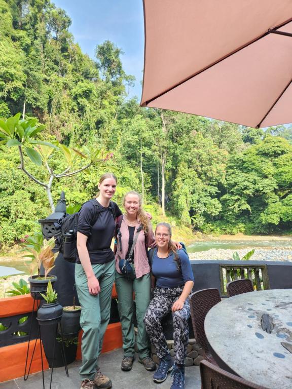 a group of people posing for a picture on a boat at Jungle Inn Bukit lawang in Bukit Lawang