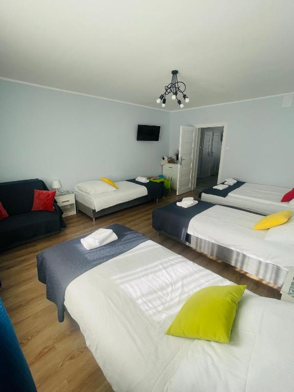 Posteľ alebo postele v izbe v ubytovaní Gladiator Noclegi Zator lV Apartament