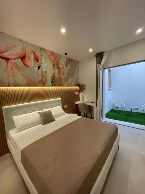 a bedroom with a large bed and a large window at Bullerjanos in Olbia