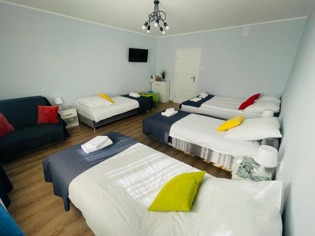 Posteľ alebo postele v izbe v ubytovaní Gladiator Noclegi Zator lV Apartament