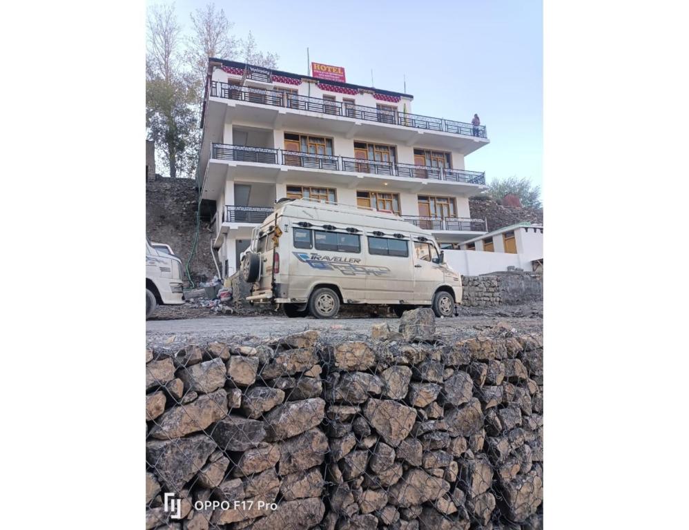 a white van parked in front of a building at Hotel Himalayan Hermitage, Kaza in Kaza