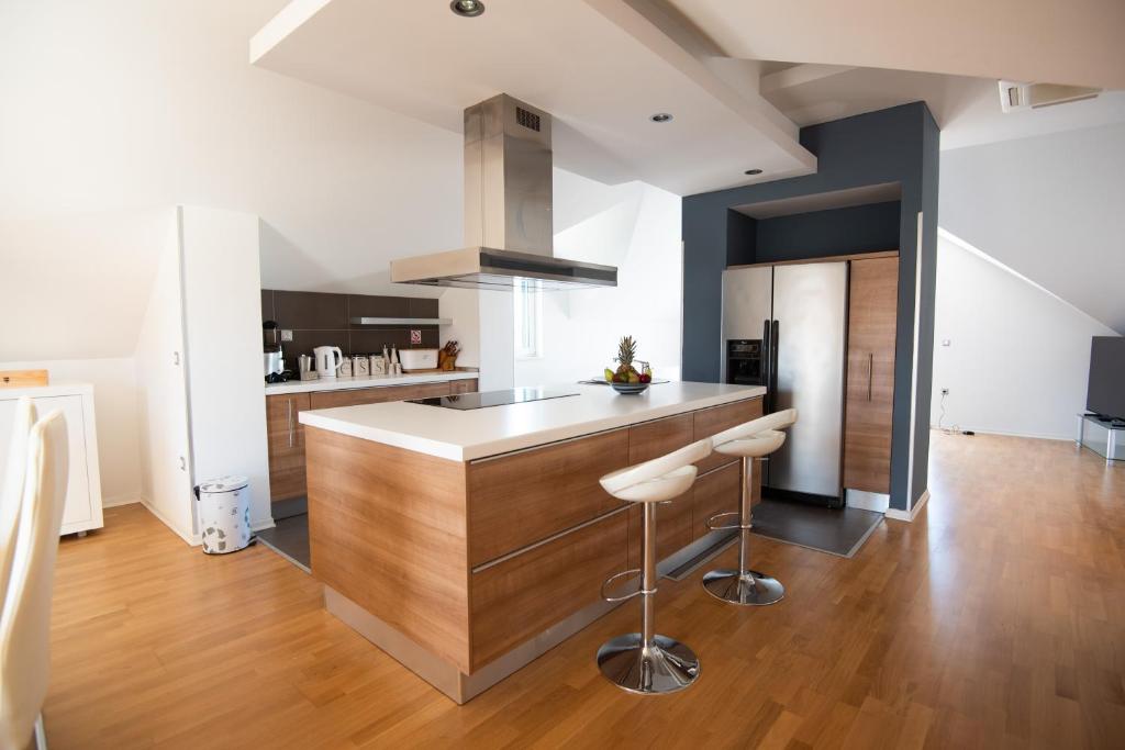 a kitchen with a counter and stools in a room at Milic Apartments - by the sea in Sutivan
