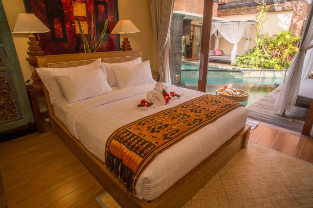 Postel nebo postele na pokoji v ubytování Tanamas Villas Ubud by Best Deals Asia Hospitality