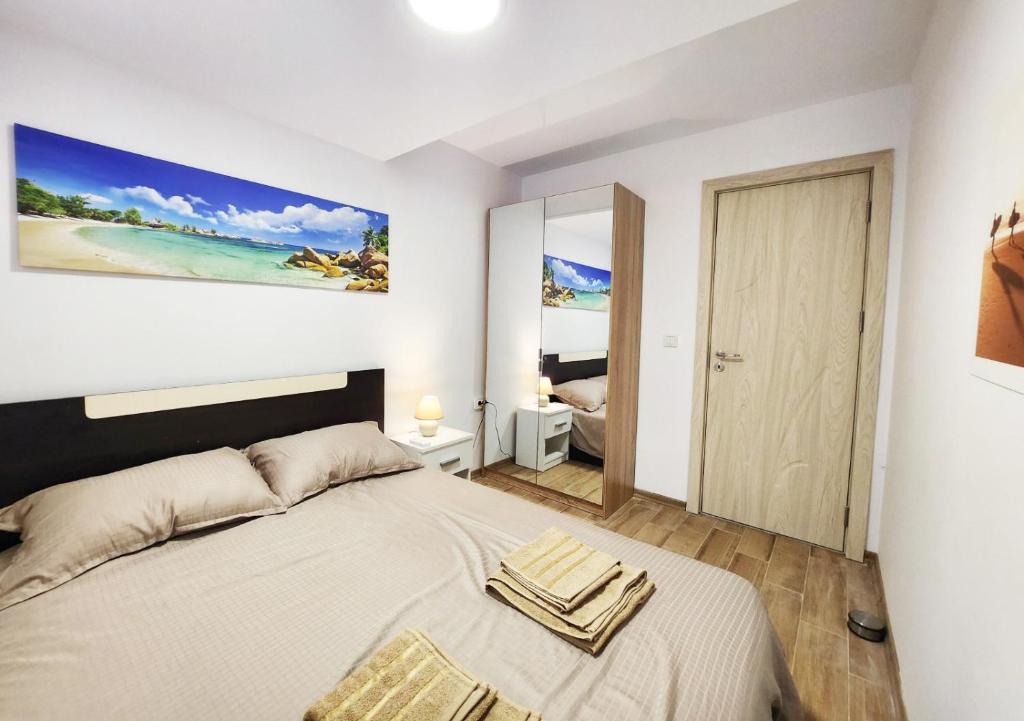 Apartment in the city of Varna في مدينة فارنا: غرفة نوم بسرير ودهان على الحائط