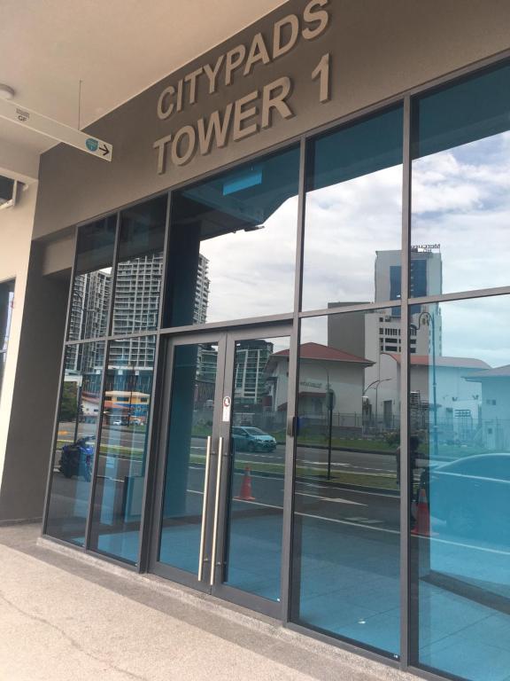 an empty cityards tower building with glass doors at LILO Staycation JQ in Kota Kinabalu