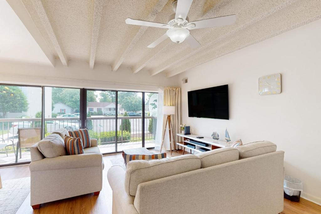 a living room with two couches and a flat screen tv at Tiburon 2C in Ocean City