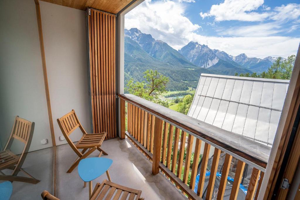 a balcony with chairs and a view of mountains at Chasa Loft 3 in Sent