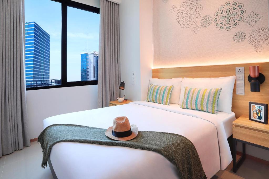 Postel nebo postele na pokoji v ubytování Citadines Gatot Subroto Jakarta