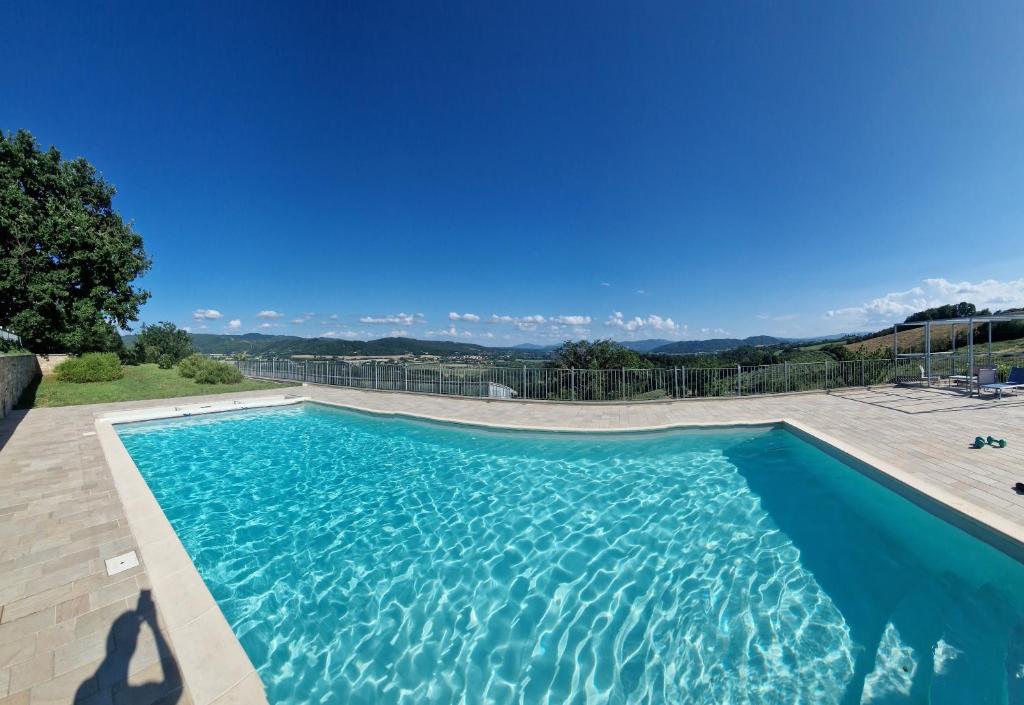 a swimming pool with a view of the mountains at Villa Spazzavento in Città di Castello