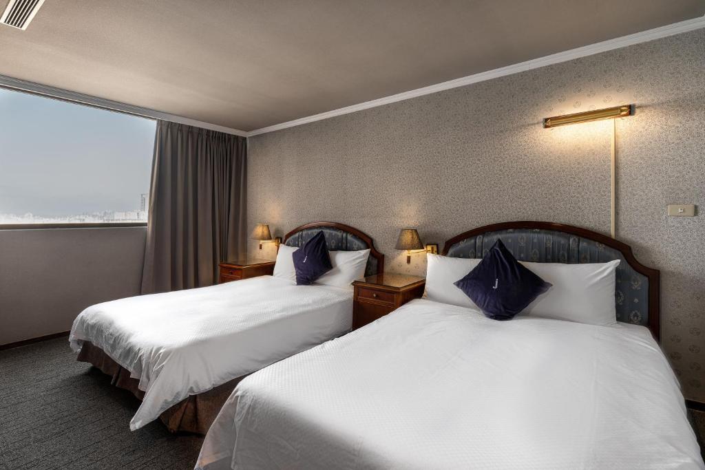 Postel nebo postele na pokoji v ubytování Hotel j-Metropolis