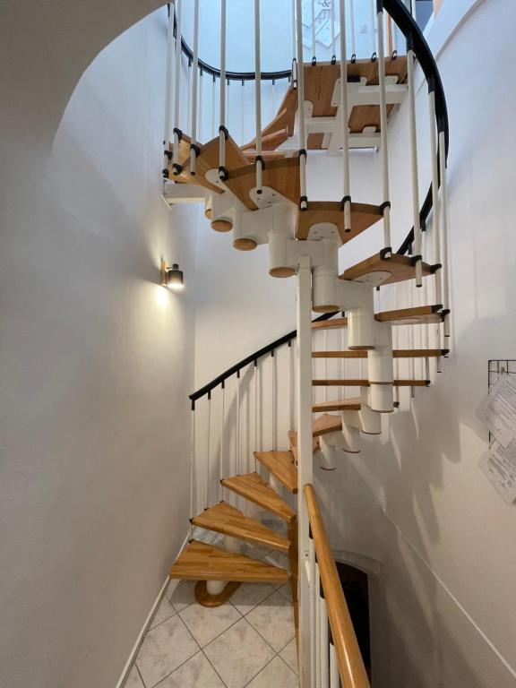 a spiral staircase in a home with a white wall at Dorfel in Košice