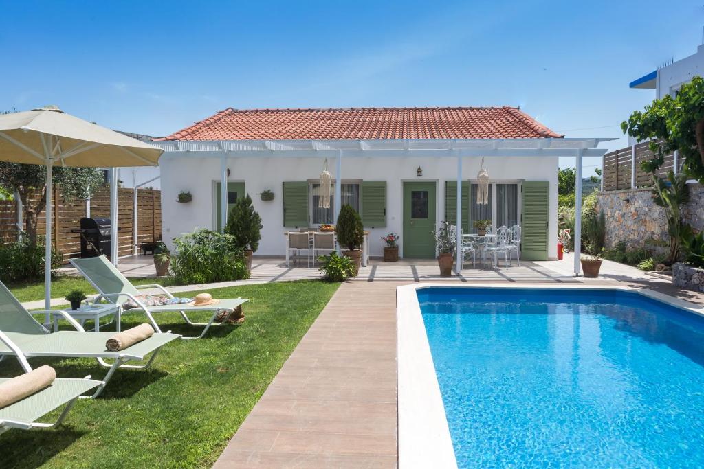 a villa with a swimming pool and a house at Pelagias Villa in Kavros