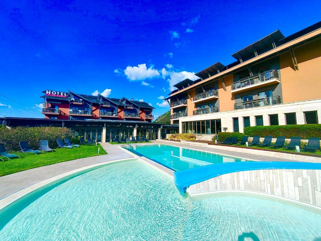 a large swimming pool in front of a building at Hotel Visegrád in Visegrád