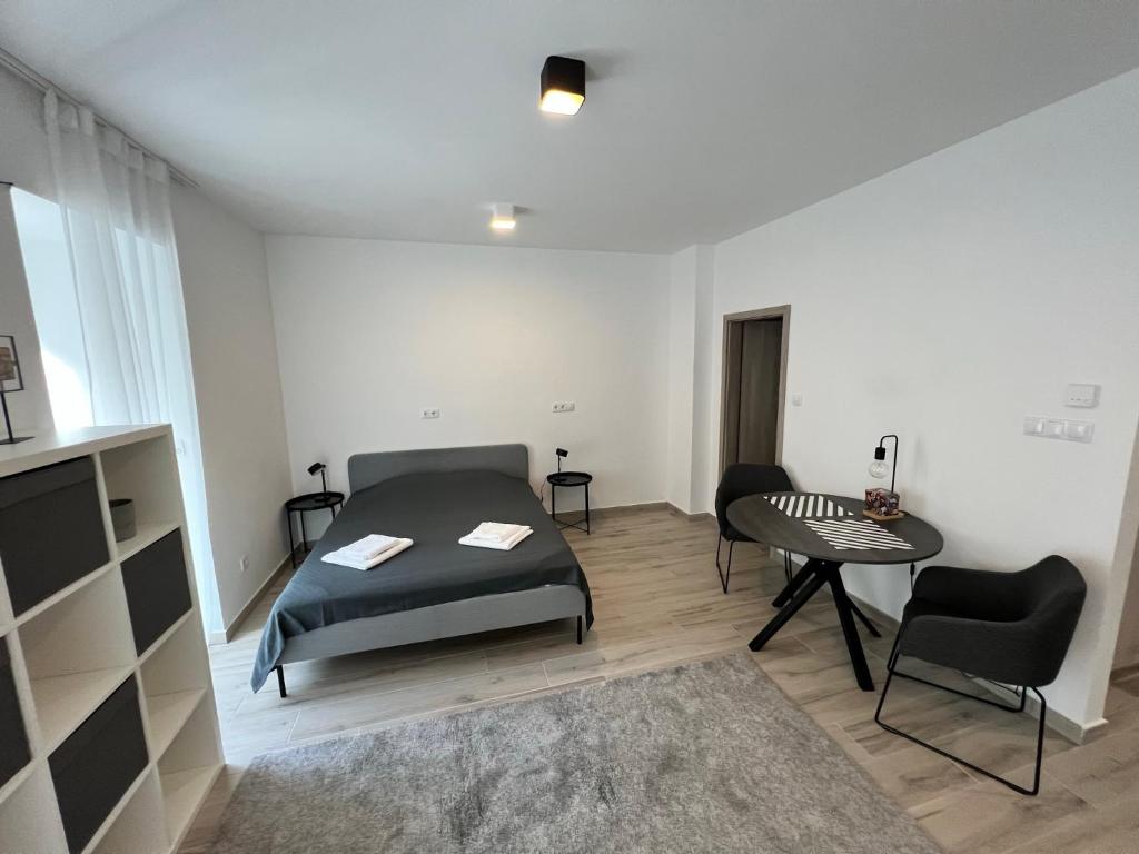 a bedroom with a bed and a table and chairs at Bez7 Apartman in Budapest