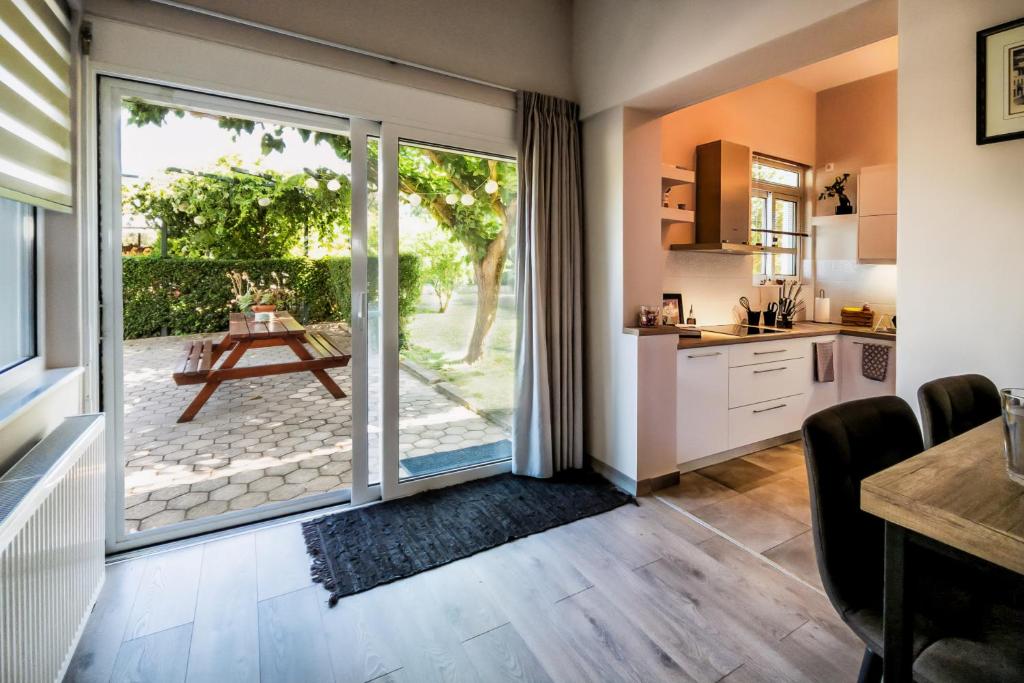 a kitchen with a sliding glass door leading to a patio at Emmy's Guesthouse in Sparti