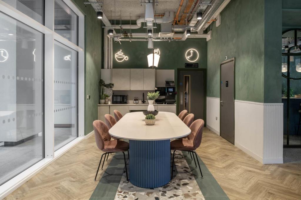 a dining room with a table and chairs at Cosy Ensuites with Shared Kitchen and Living Area at Alma Place in the heart of Belfast in Belfast