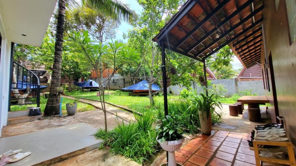 a patio with a yard with tents in the background at CL Homestay in Senmonorom