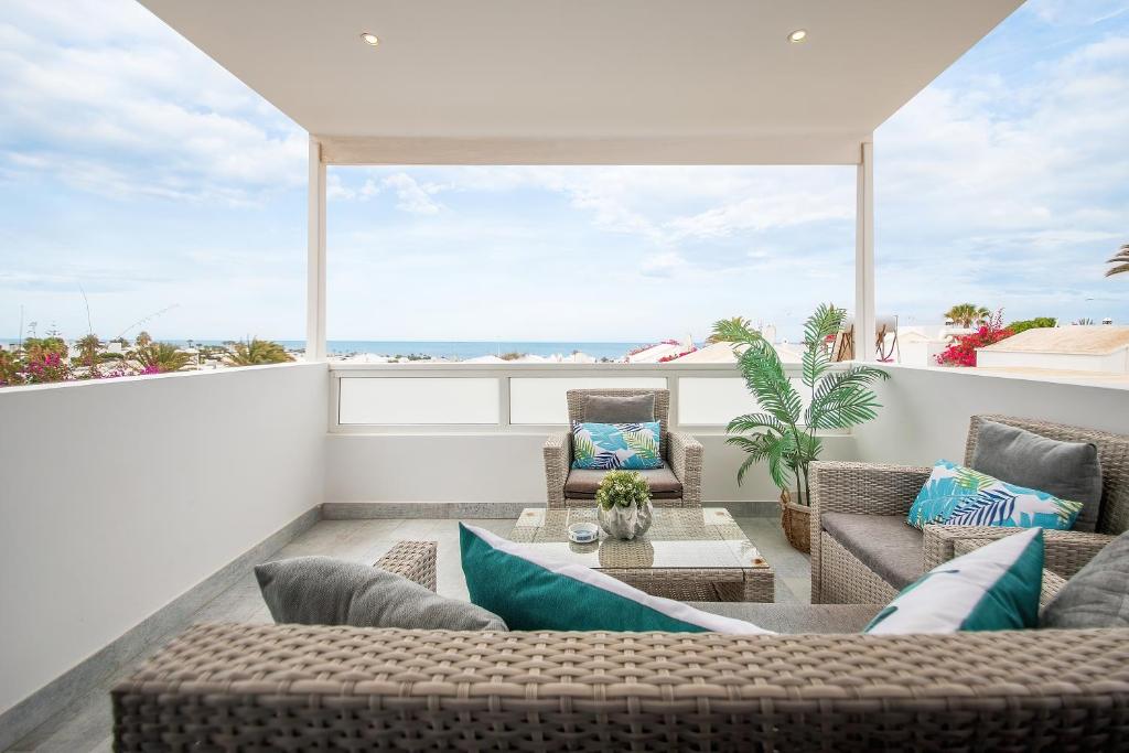 a patio with couches and a table on a balcony at Apartamento Alma in Puerto del Carmen