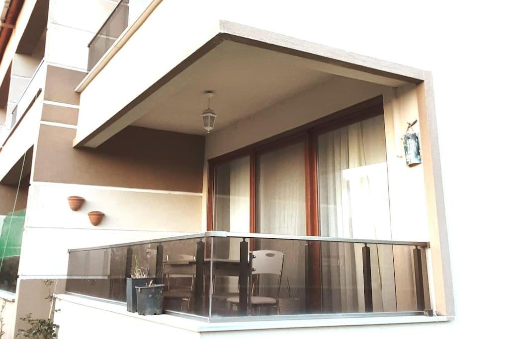 a balcony with a table and chairs on a building at ERDEK in Erdek