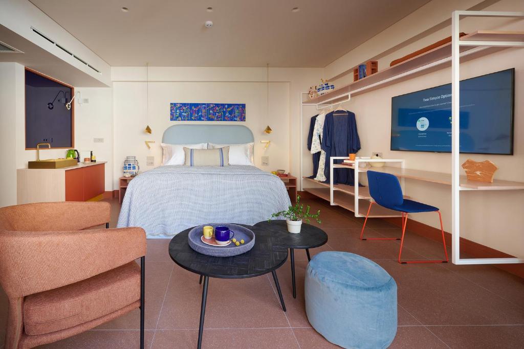 1 dormitorio con 1 cama, mesa y sillas en LOOM ATHENS en Athens