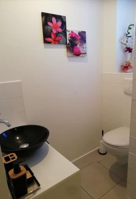 a bathroom with a black sink and a toilet at L&#39;Ornella Dom Studio en copropriété in Marseille