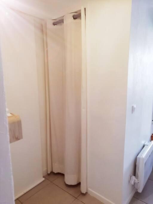 a bathroom with white walls and a white door at L&#39;Ornella Dom Studio en copropriété in Marseille