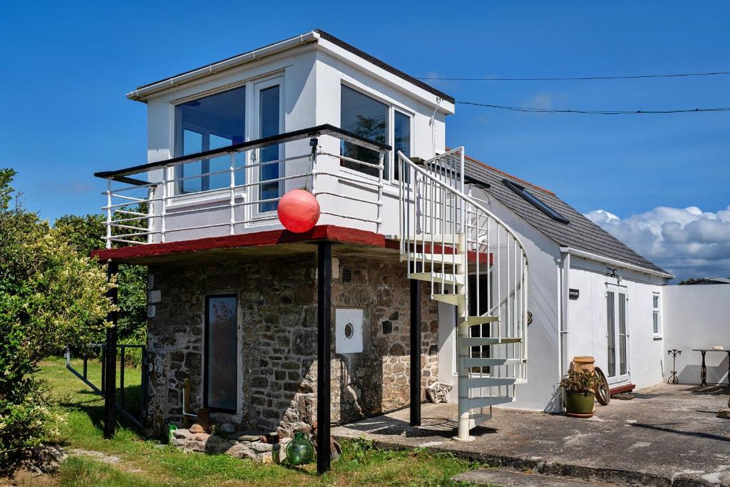 a house with a red ball on top of it at Finest Retreats - The Watchtower at Western Watch in Lower Boscaswell