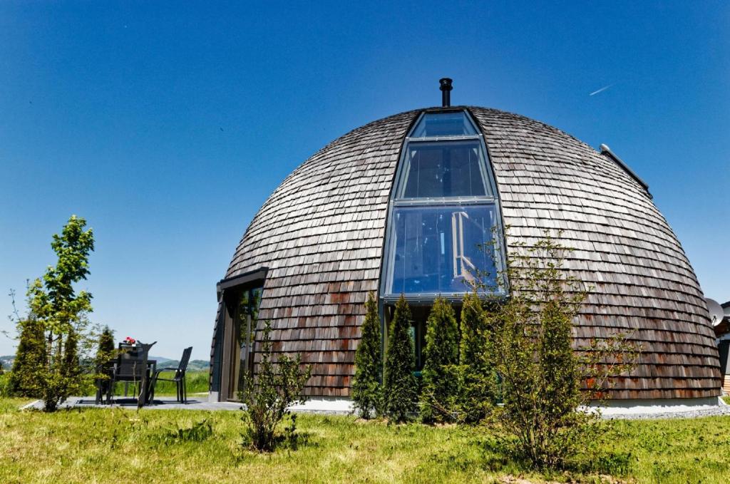 a large dome building with a window on a field at Chalet Panorama-Skydome in Neukirchen vorm Wald