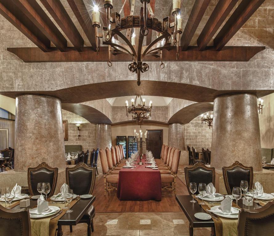 a dining room with a long table with chairs and a chandelier at Spice Hotel & Spa - Ultra All Inclusive in Belek