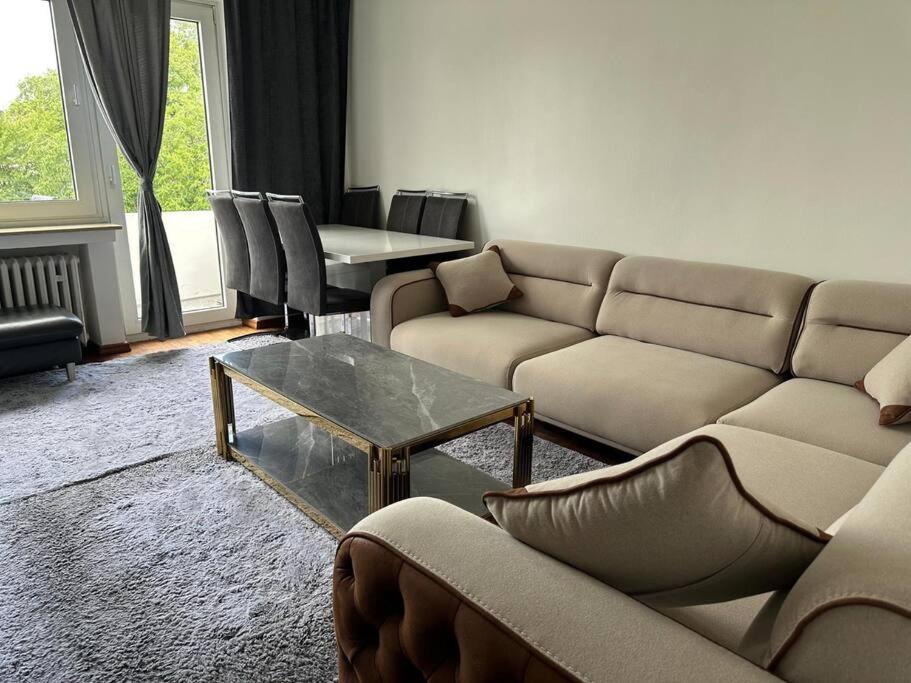 a living room with couches and a coffee table at Luxus Apartment in duisburg in Duisburg